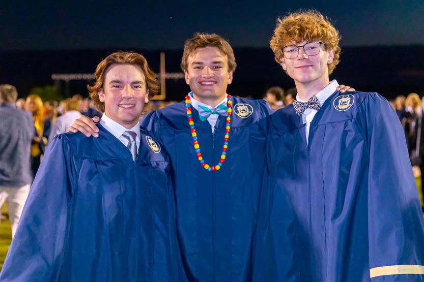 Students wearing blue graduation robes